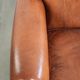 Comfortable vintage sheepskin armchair finished with decorative nails