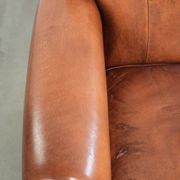 Comfortable vintage sheepskin armchair finished with decorative nails