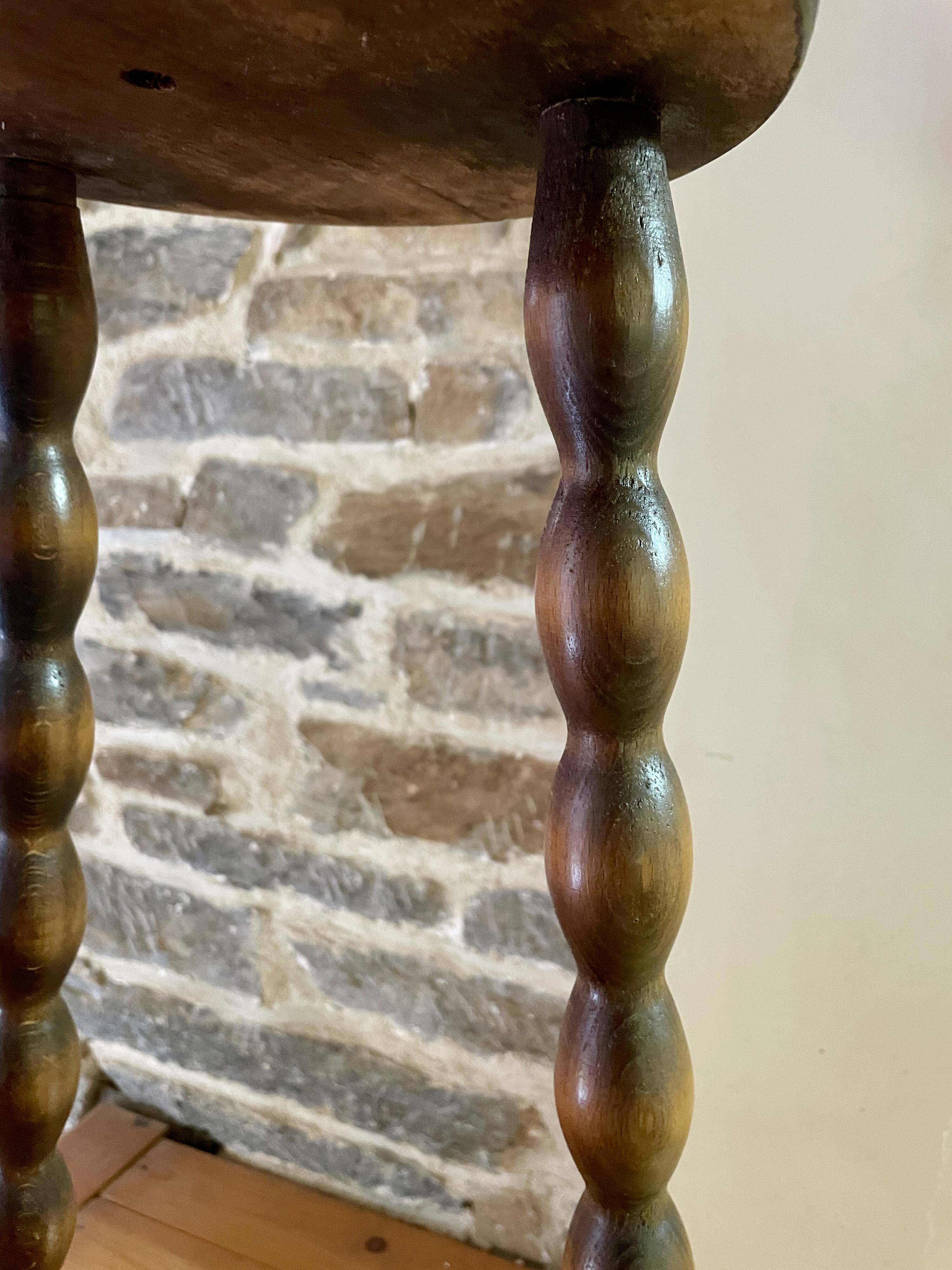 High stool in beaded wood - spool legs