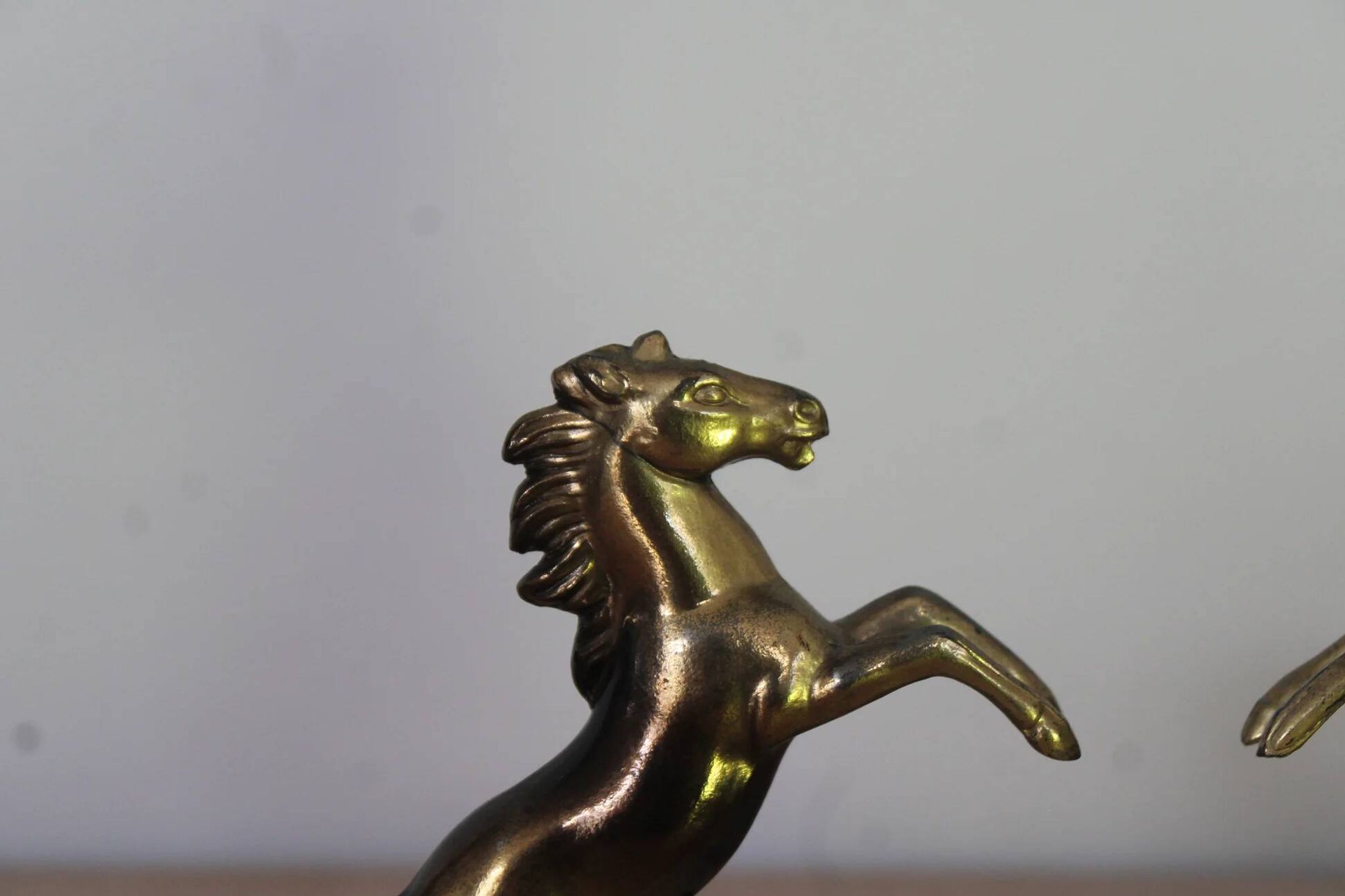 Pair of vintage bookends with rearing horses in gilded metal on marble bases.