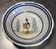 Large centrepiece table dish in earthenware with a painted decoration of a drummer.
