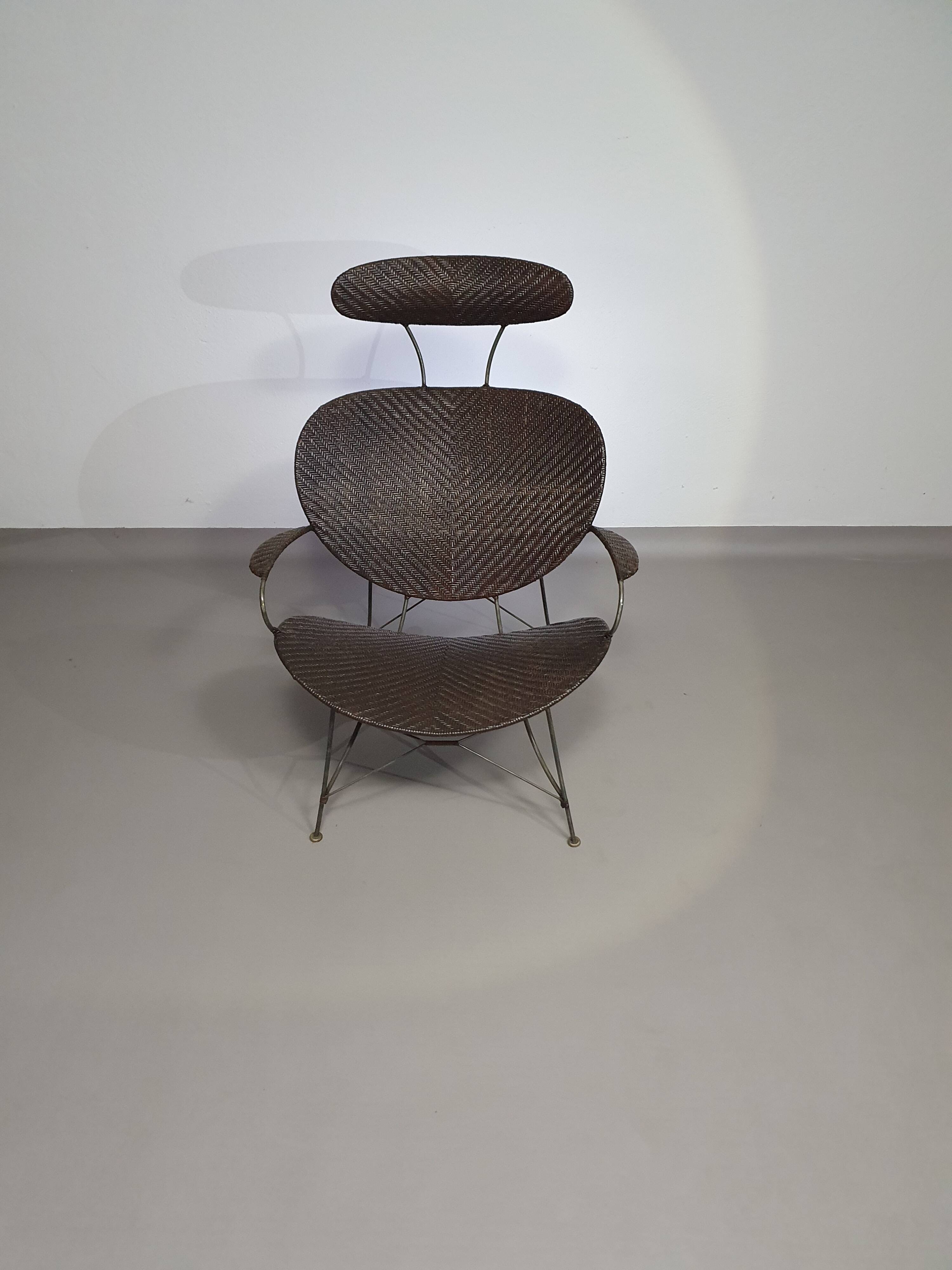 Armchair designed by Yuzuru Yamakawa  Metal frame.  Seat and back in braided rattan.