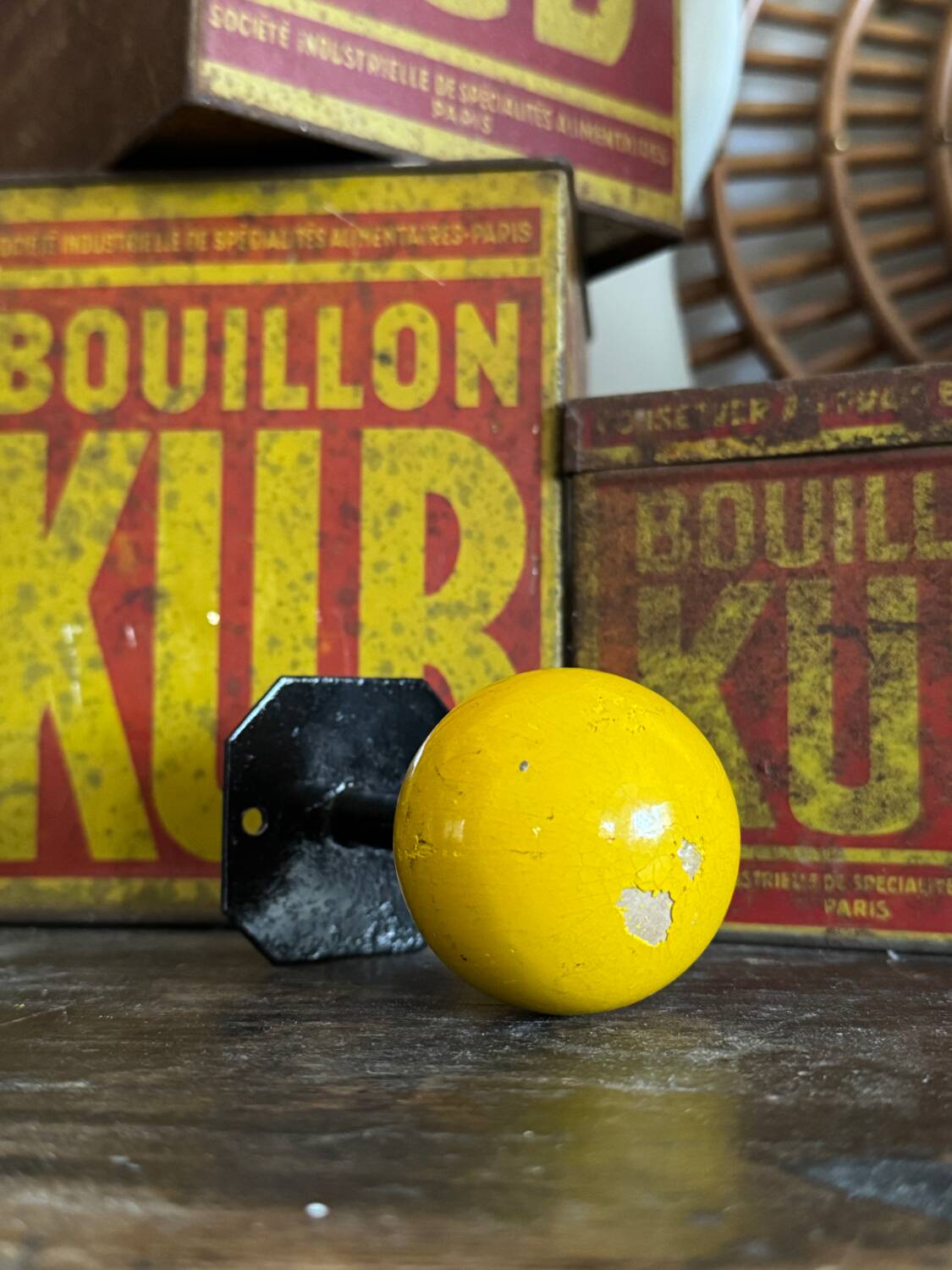 Vintage yellow wooden wall-mounted ball coat hook.