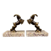 Pair of Art Deco bookends with patinated spelter ibex and veined marble.