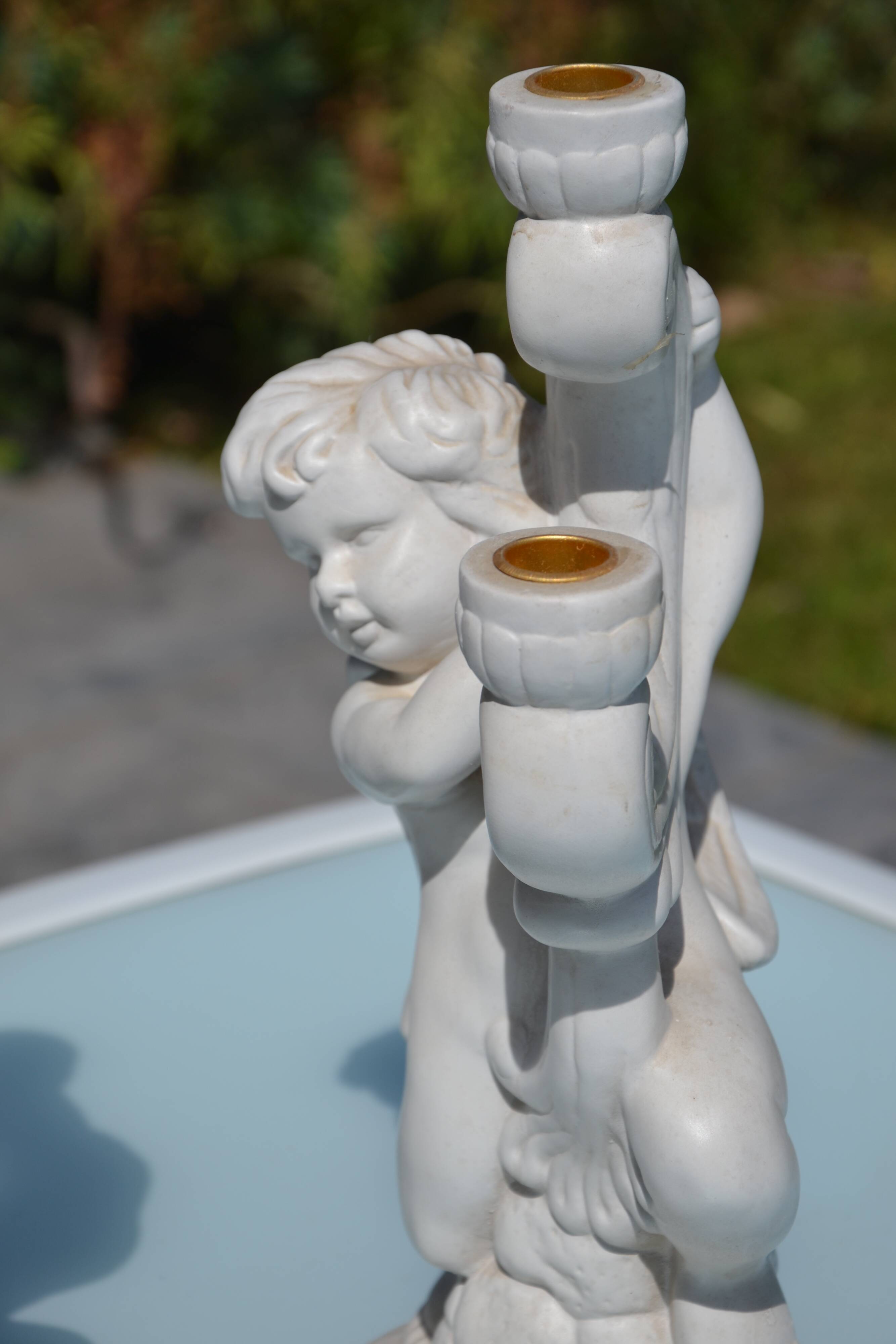 Pair of "cherub" candle holders in plaster