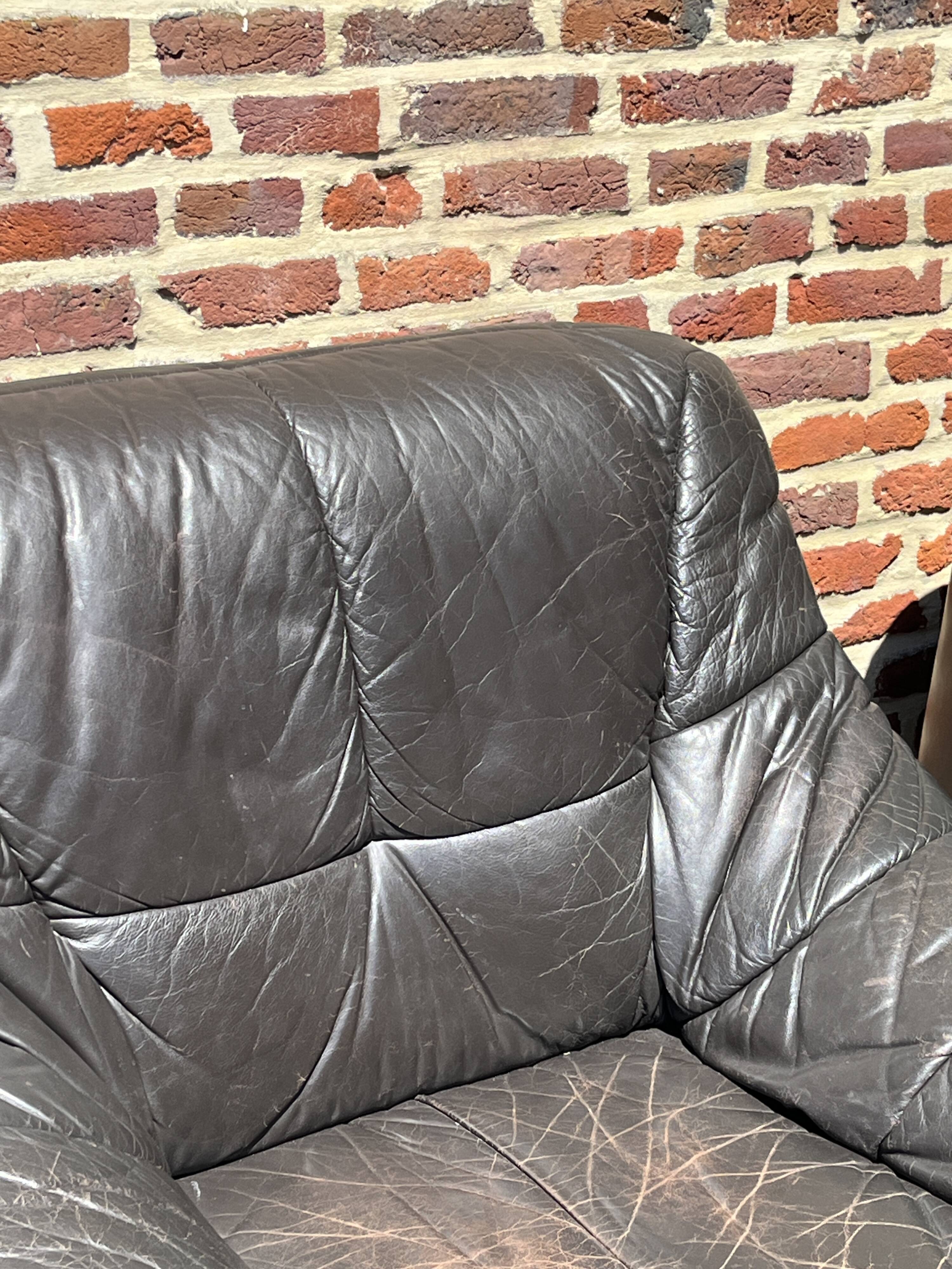 Pair of patinated leather club armchairs