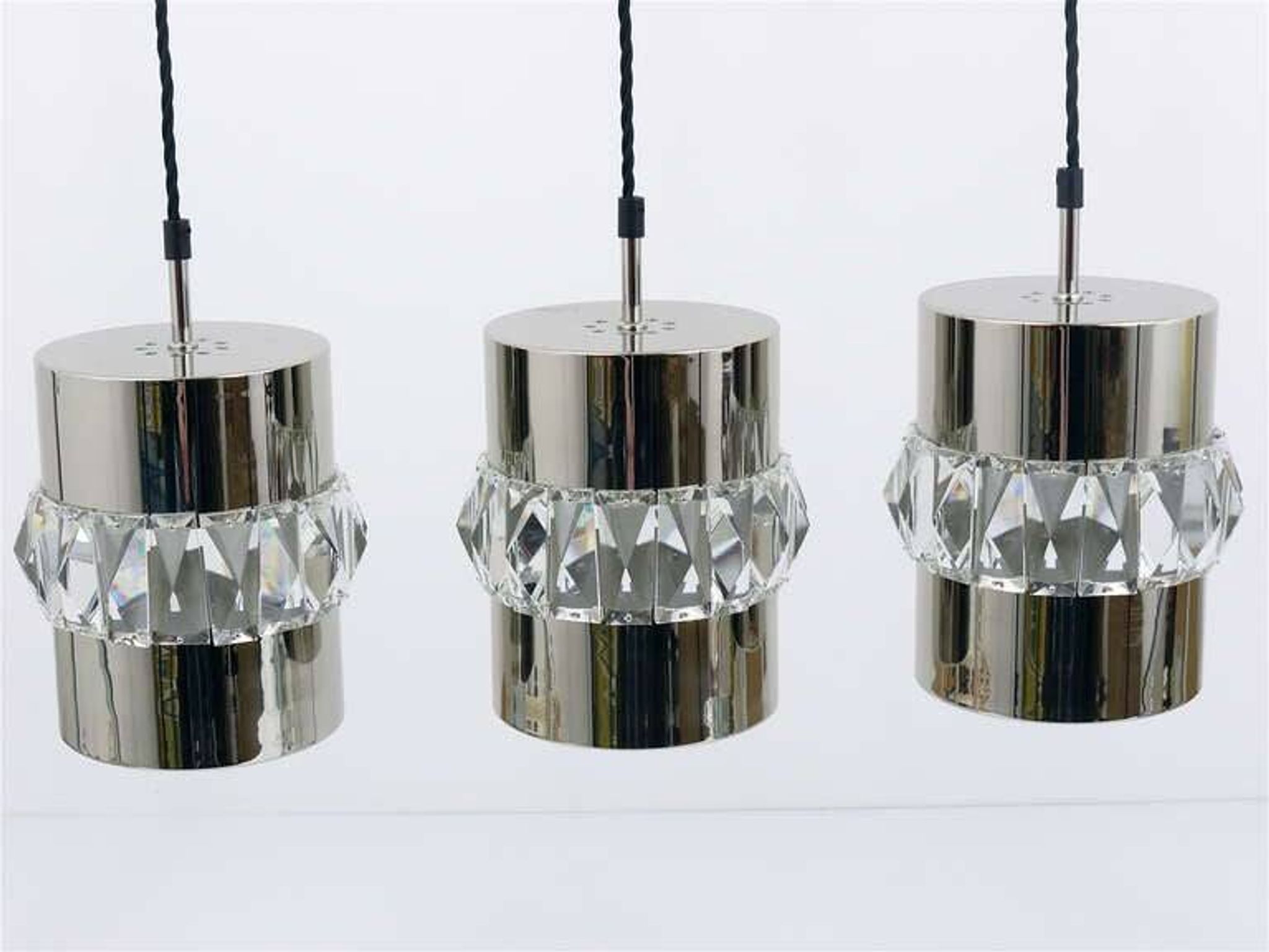 Three Bakalowits pendant lamps in nickel, brass, and faceted crystal, Austria, 1950s.