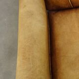 Unique children’s armchair made of cowhide leather in Art Deco style, featuring a light cognac color