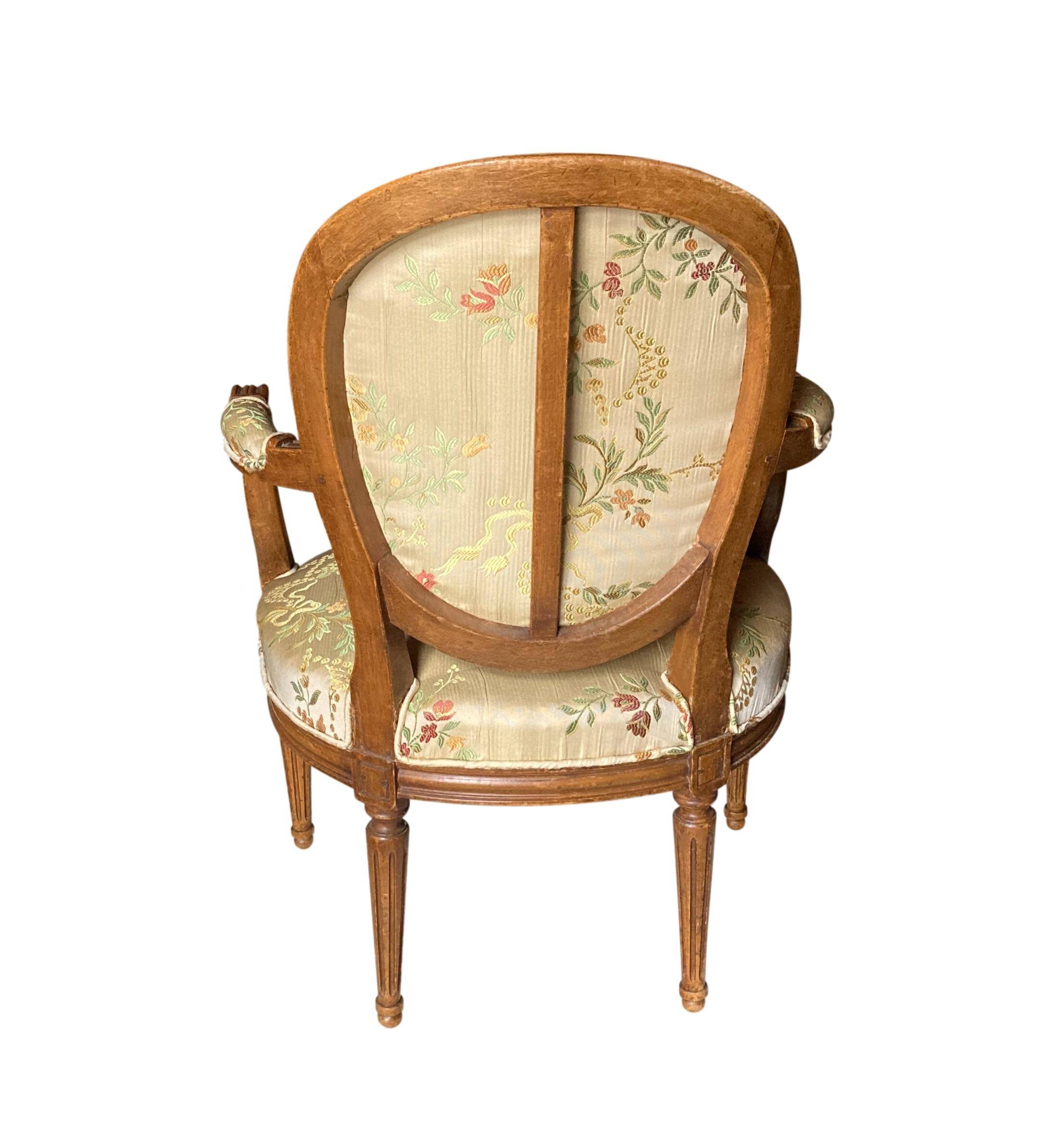 Pair of Louis XVI silk cabriolet armchairs