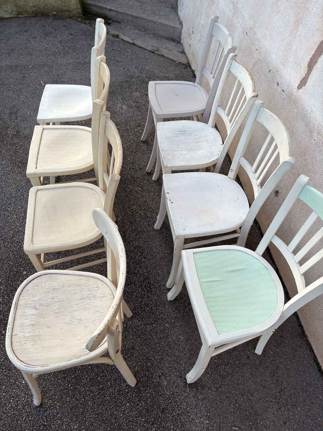 Set of 8 mismatched white bistro chairs