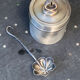 Sprinkling spoon and art deco sugar pot in silver metal