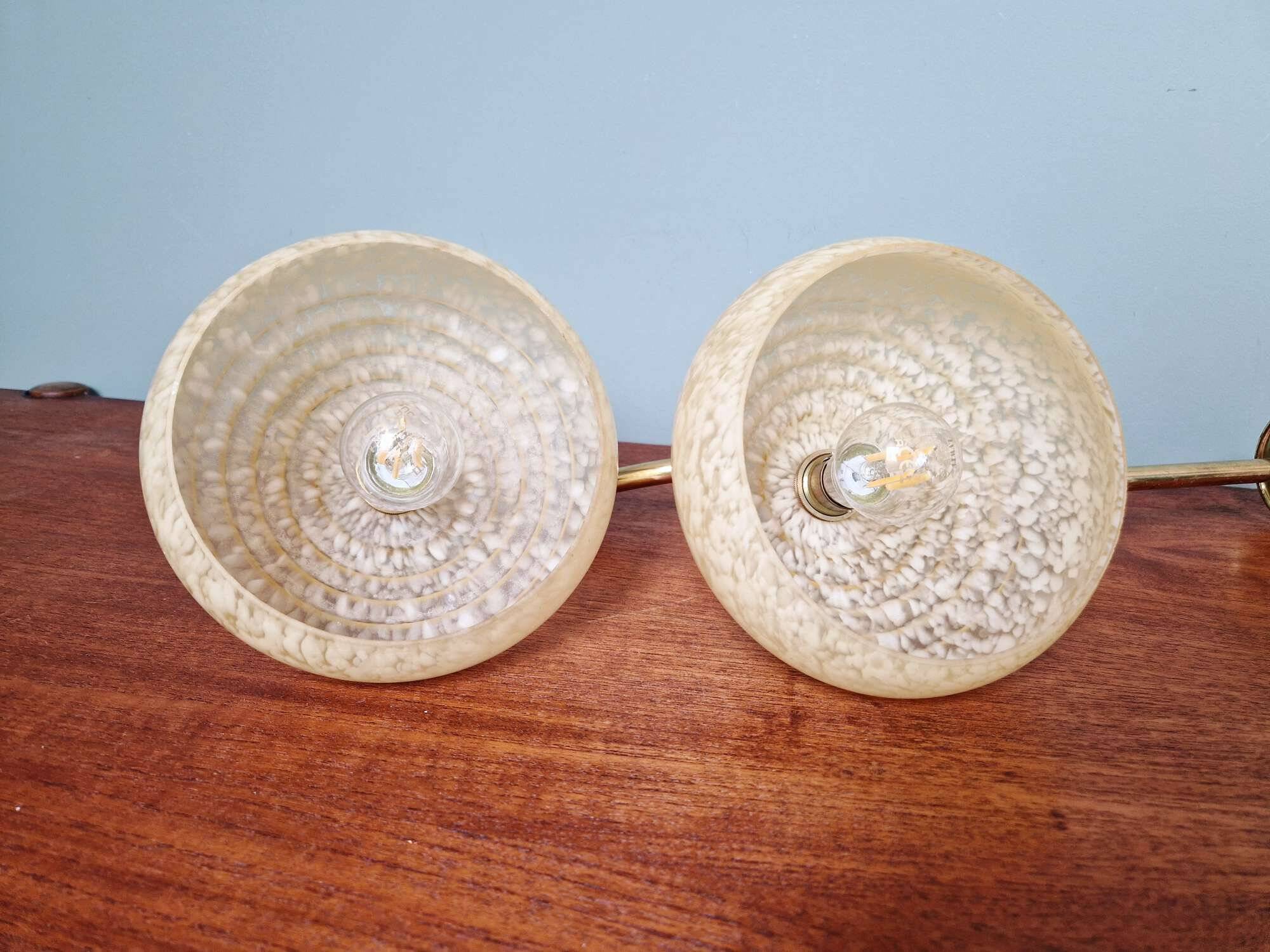 Pair of brass and yellow/white speckled glass wall sconces