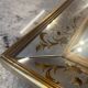 Large Venetian-style mirror with golden floral decoration.