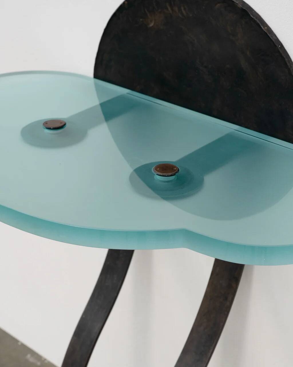 Artisanal wrought iron and cast glass leaning console table