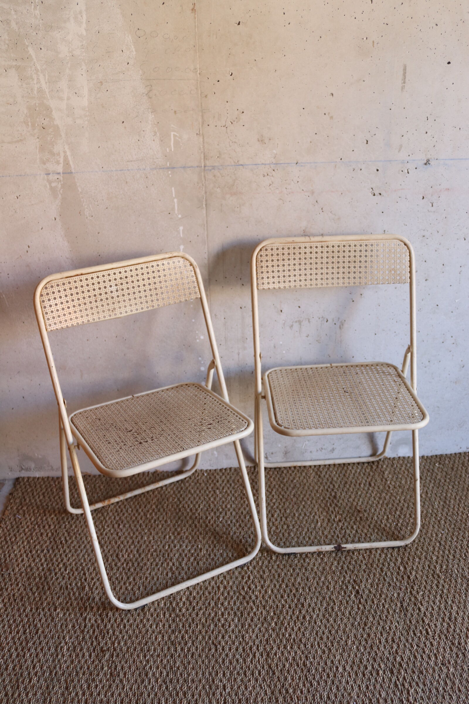 Two metal tanned folding chairs