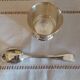 Egg cup and spoon in silver metal