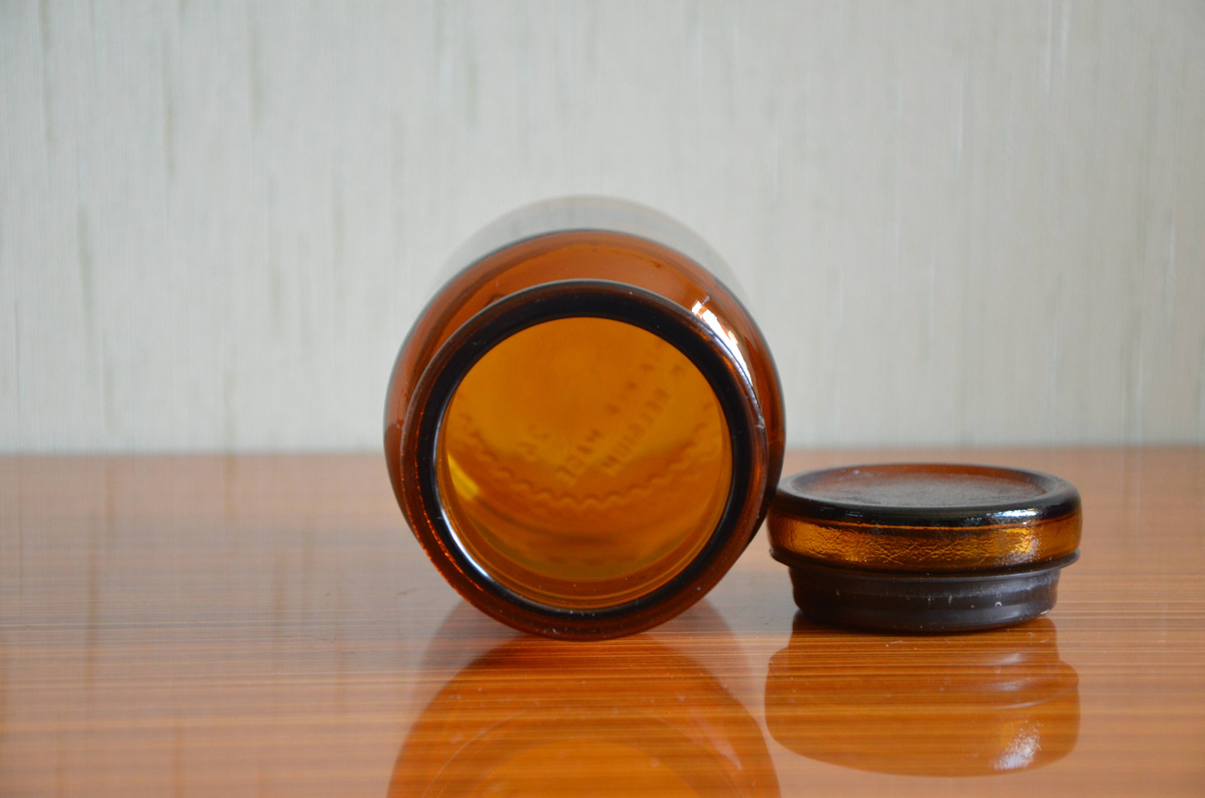 Small jar of amber glass apothecary with a flat cap