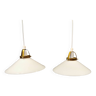 A set of hanging lamps in milky white opal glass with brass top.