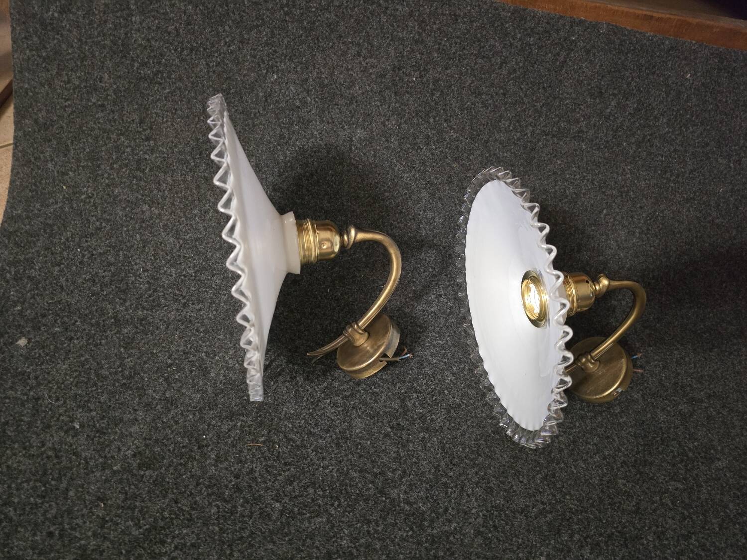 Wall sconces with scalloped opaline lampshades.