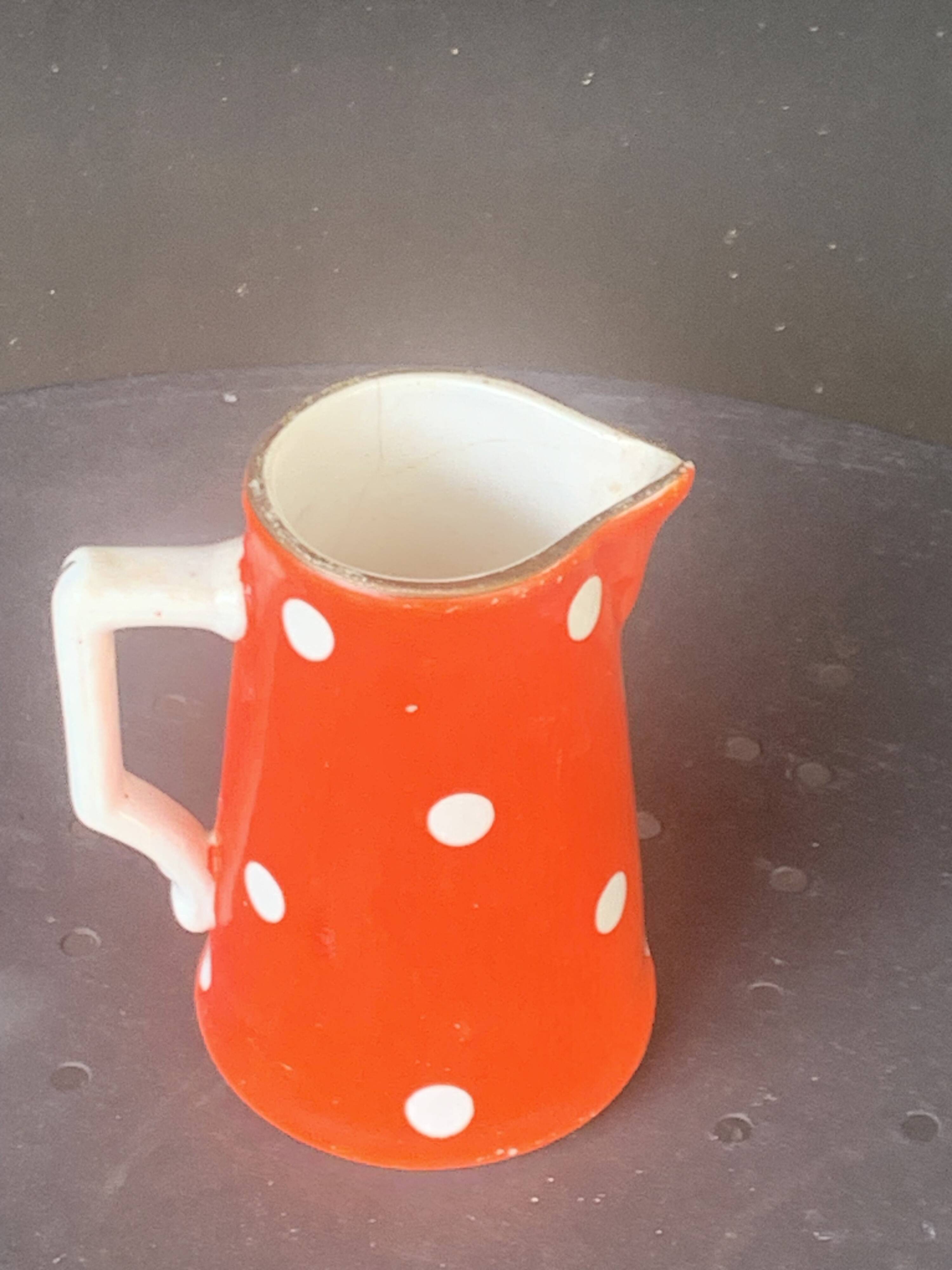 Milk jug, pitcher with white polka dots on orange earthenware, Sarreguemines and Digoin