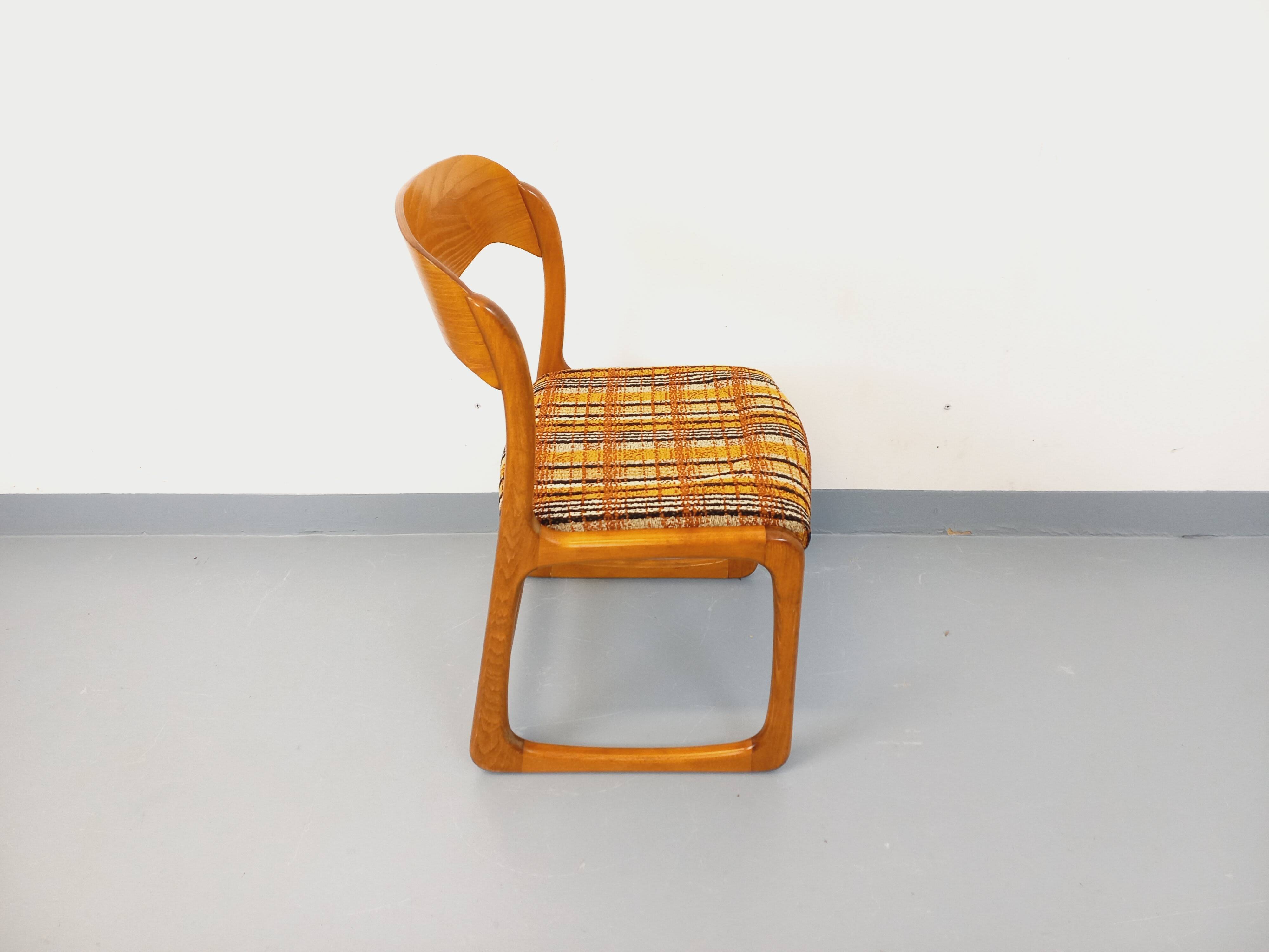 Vintage sled chair by Baumann in wood and wool fabric.