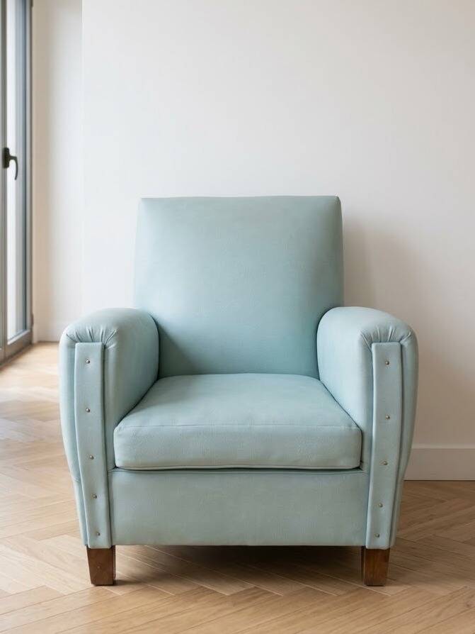 Vintage armchair in light blue faux leather retro style
