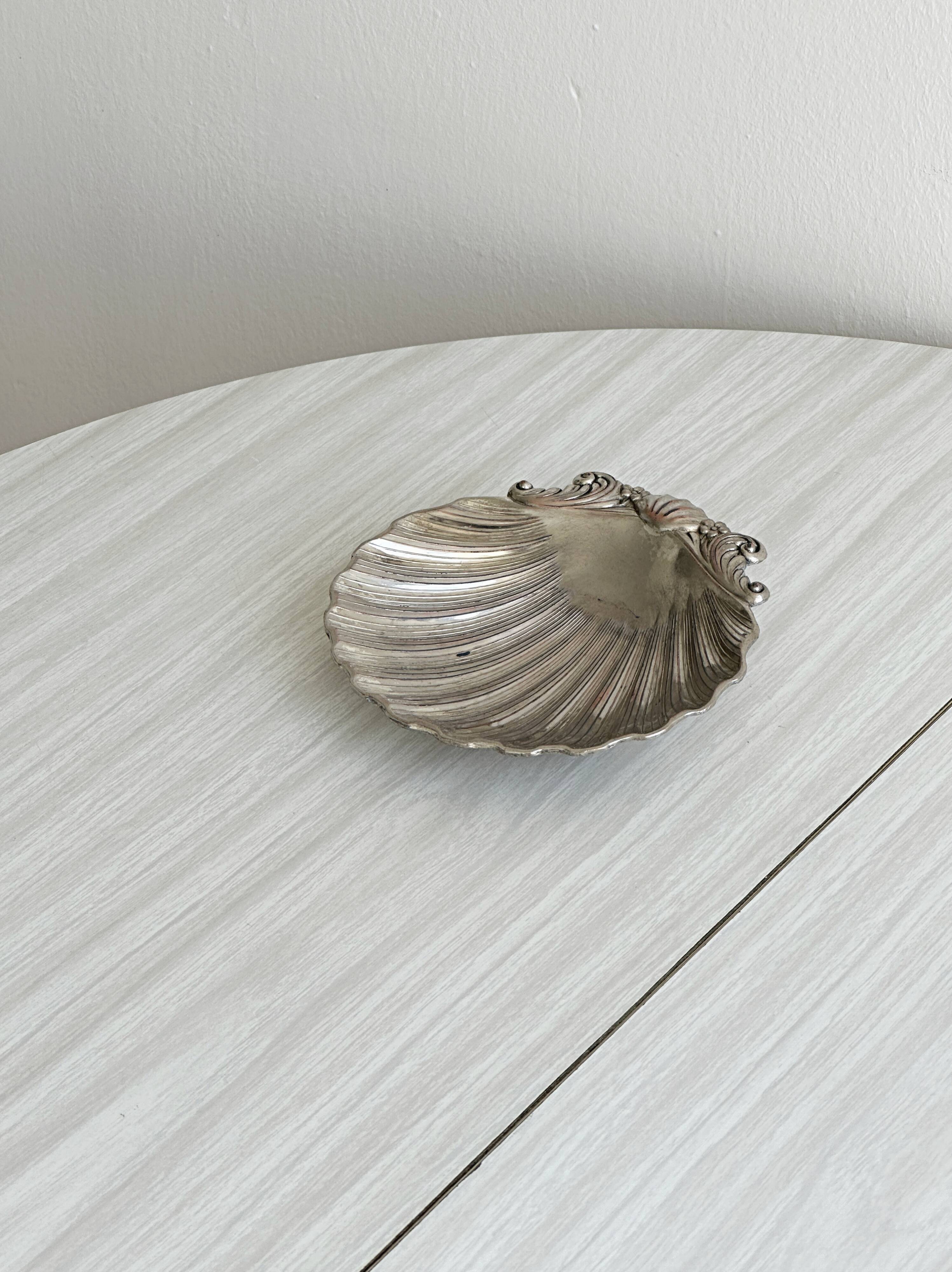 shell-shaped metal pocket tray with patina