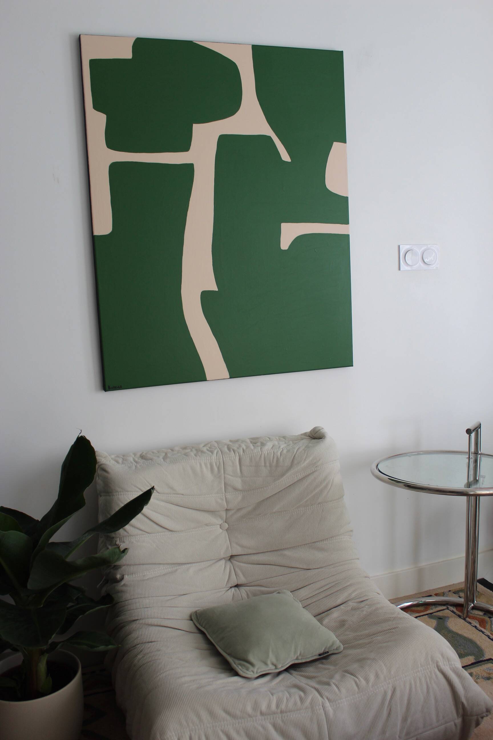 Abstract green art on a beige background.