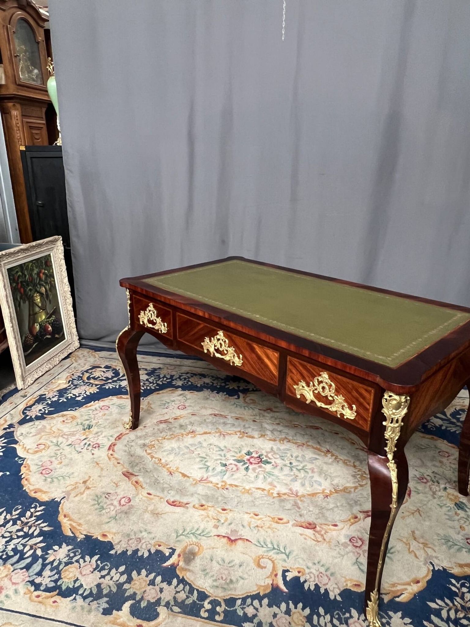 Louis XV style desk. Rosewood veneer, gilt bronze decoration, leather.