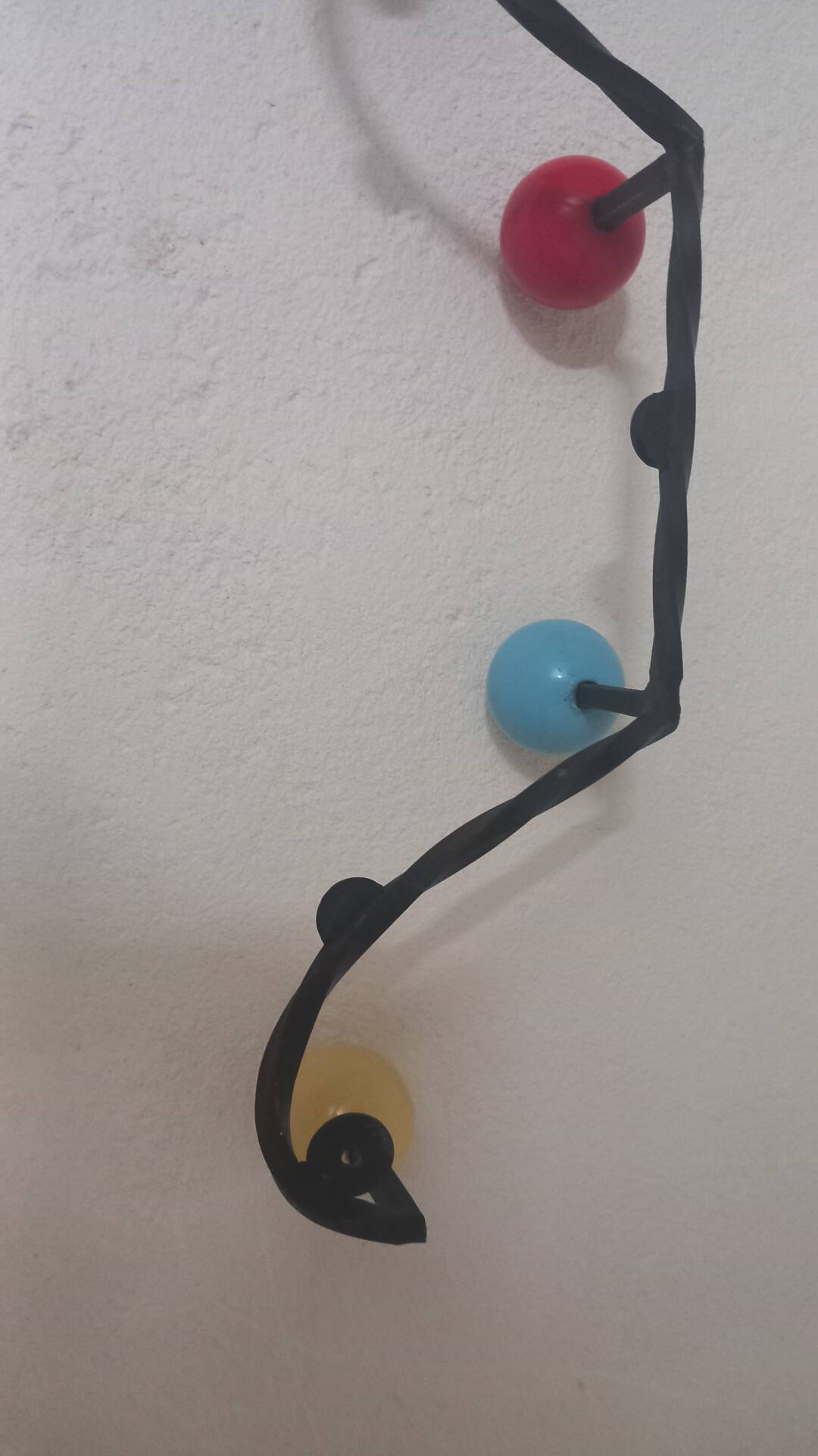 Vintage wall coat rack "Atomic" in wrought iron with multicoloured balls.
