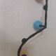 Vintage wall coat rack "Atomic" in wrought iron with multicoloured balls.