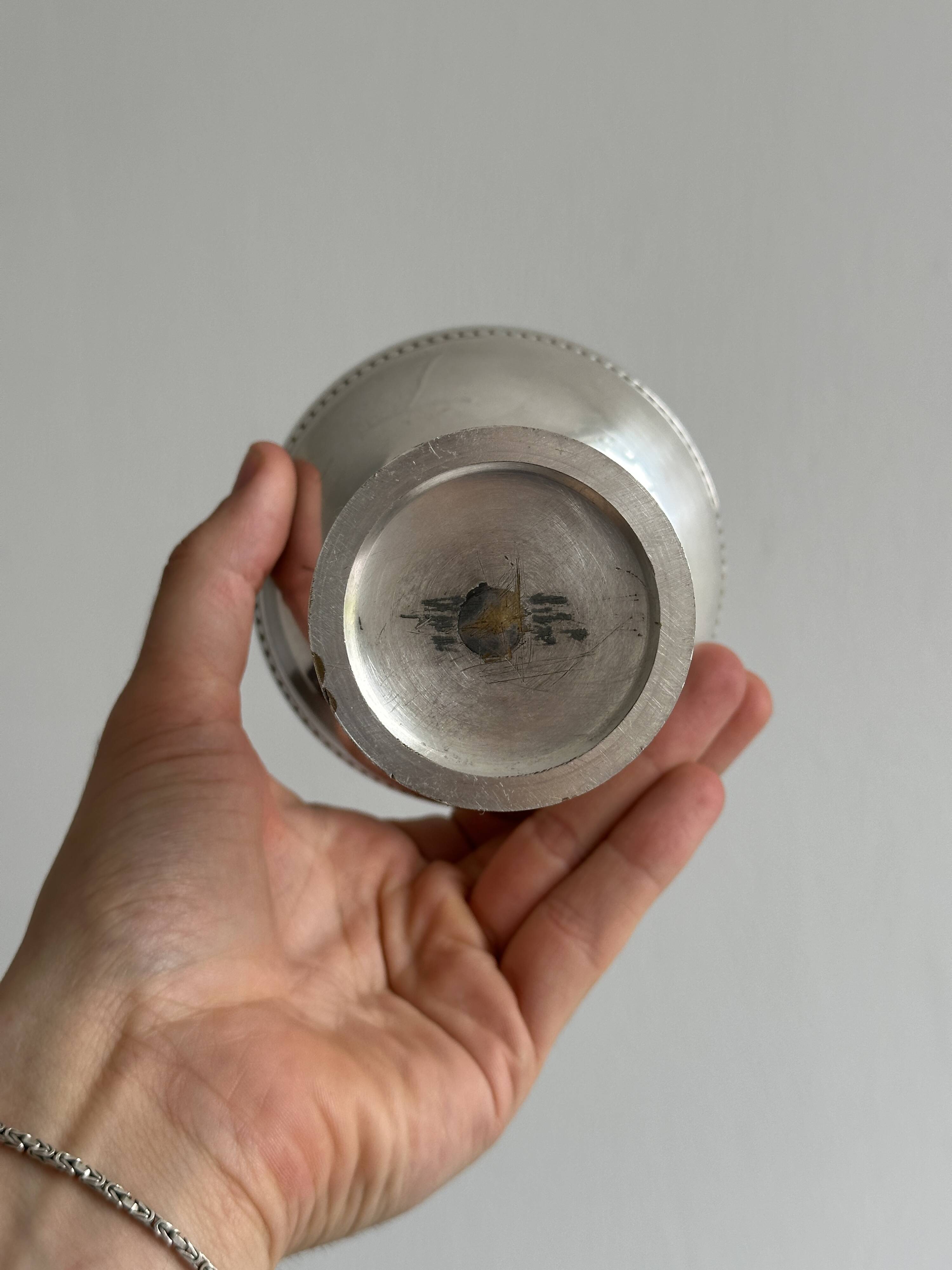 Silver-plated metal bowl on a stand