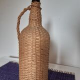 Old high wicker glass bottle