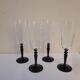 4 clear glass flutes with black stems. 1960–1970. 4 clear glass flutes with black stems.