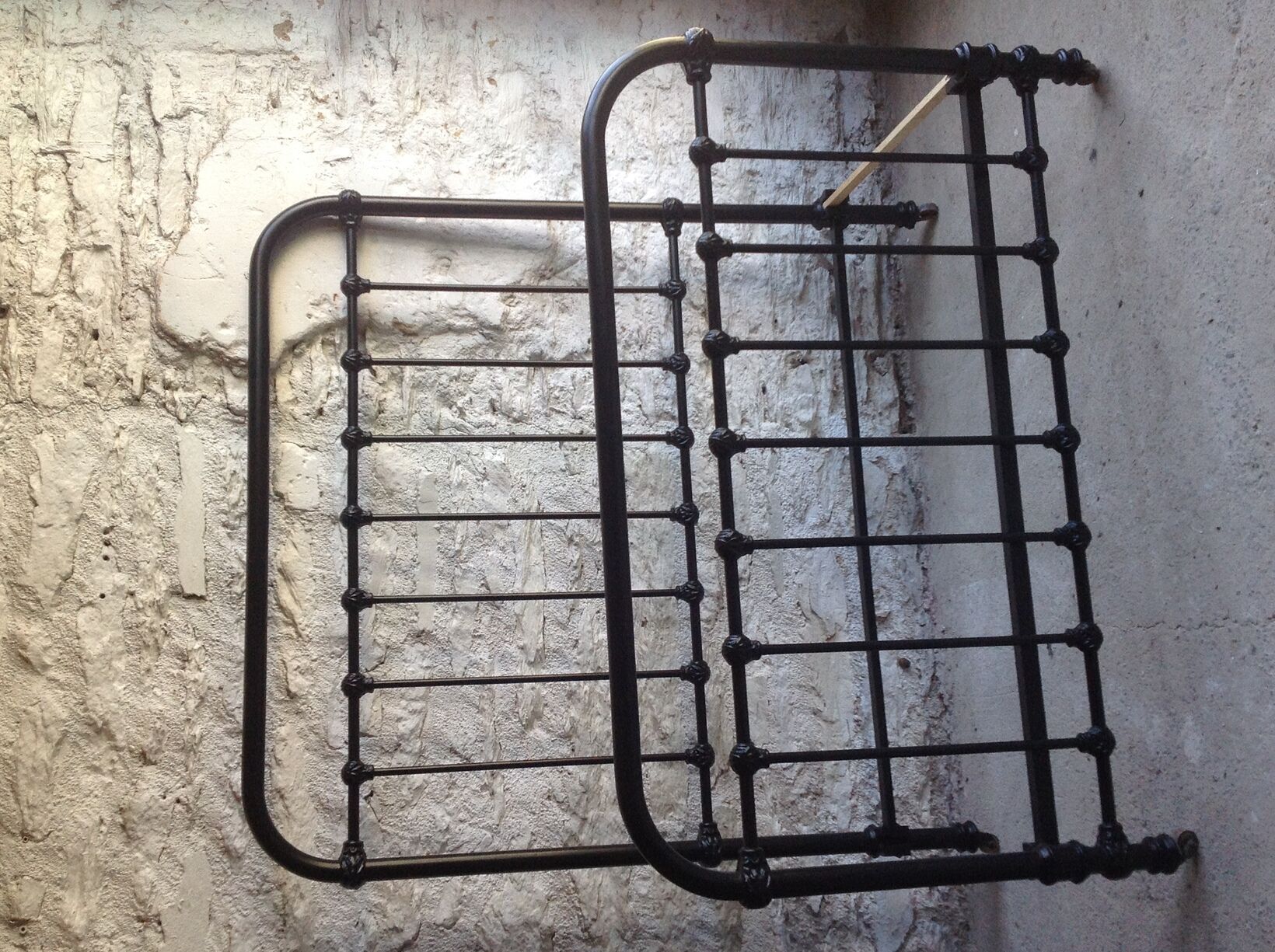 old bed with vintage painted metal bars