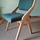 Scandinavian green chairs with tapered legs.