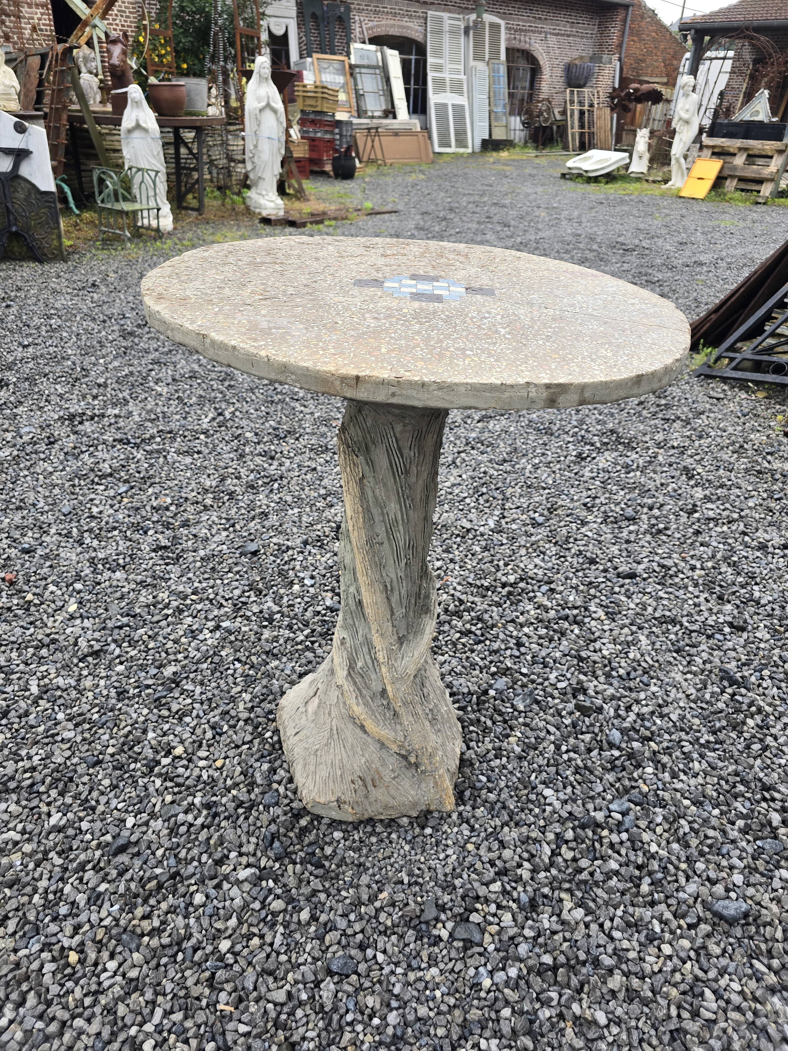 Cement garden table with trunk-shaped foot