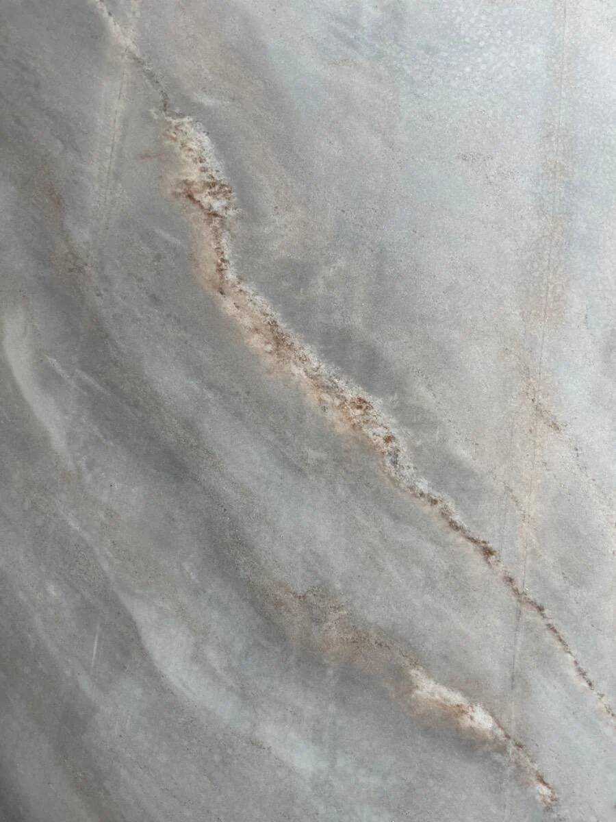 Light gray solid granite coffee table with organic triangular shape and conical base, 1980s