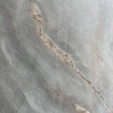 Light gray solid granite coffee table with organic triangular shape and conical base, 1980s