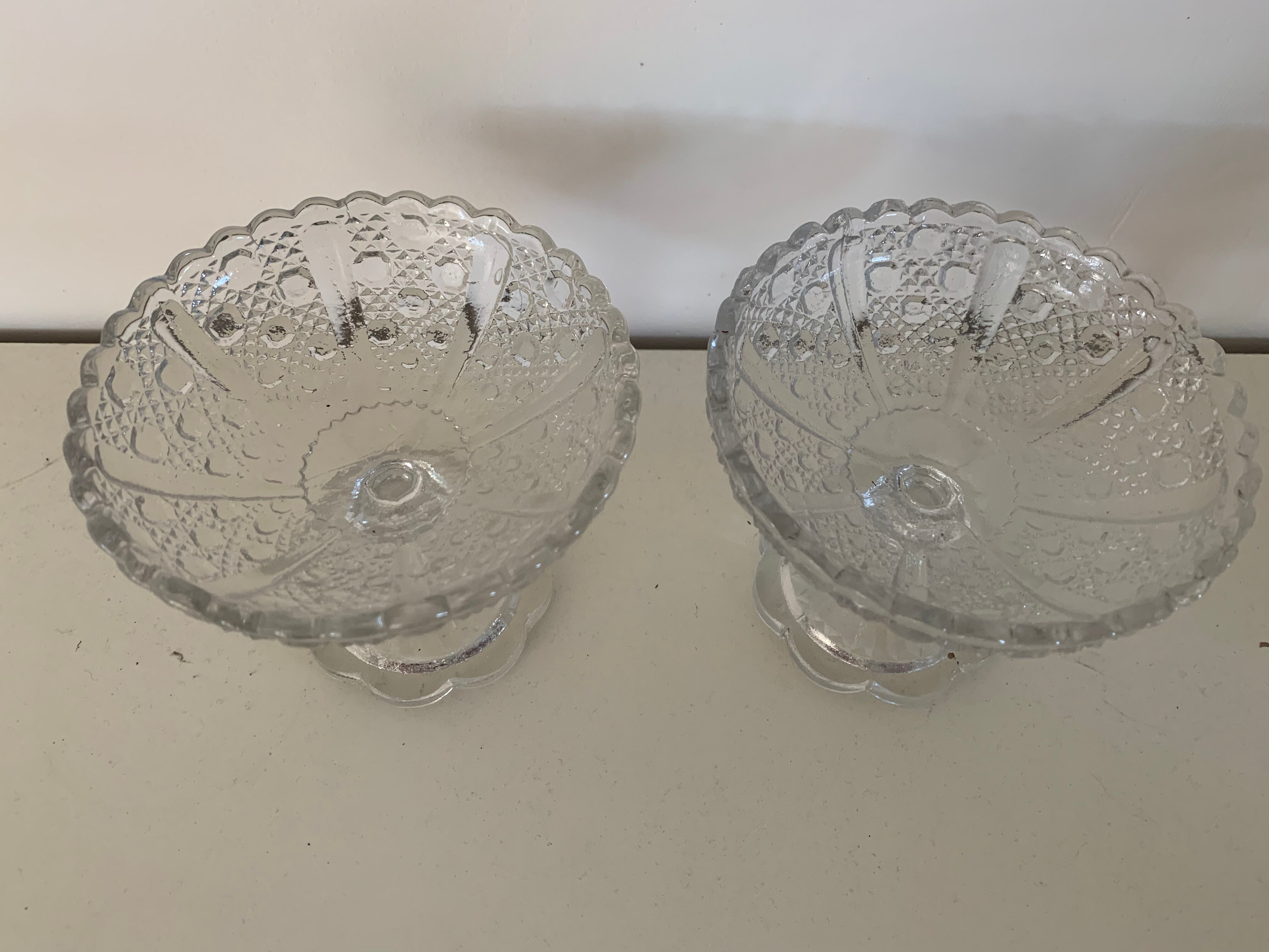 Two dredged cups in transparent glass geometric patterns in old relief