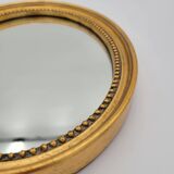 Small old oval mirror in gilded wood