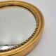 Small old oval mirror in gilded wood
