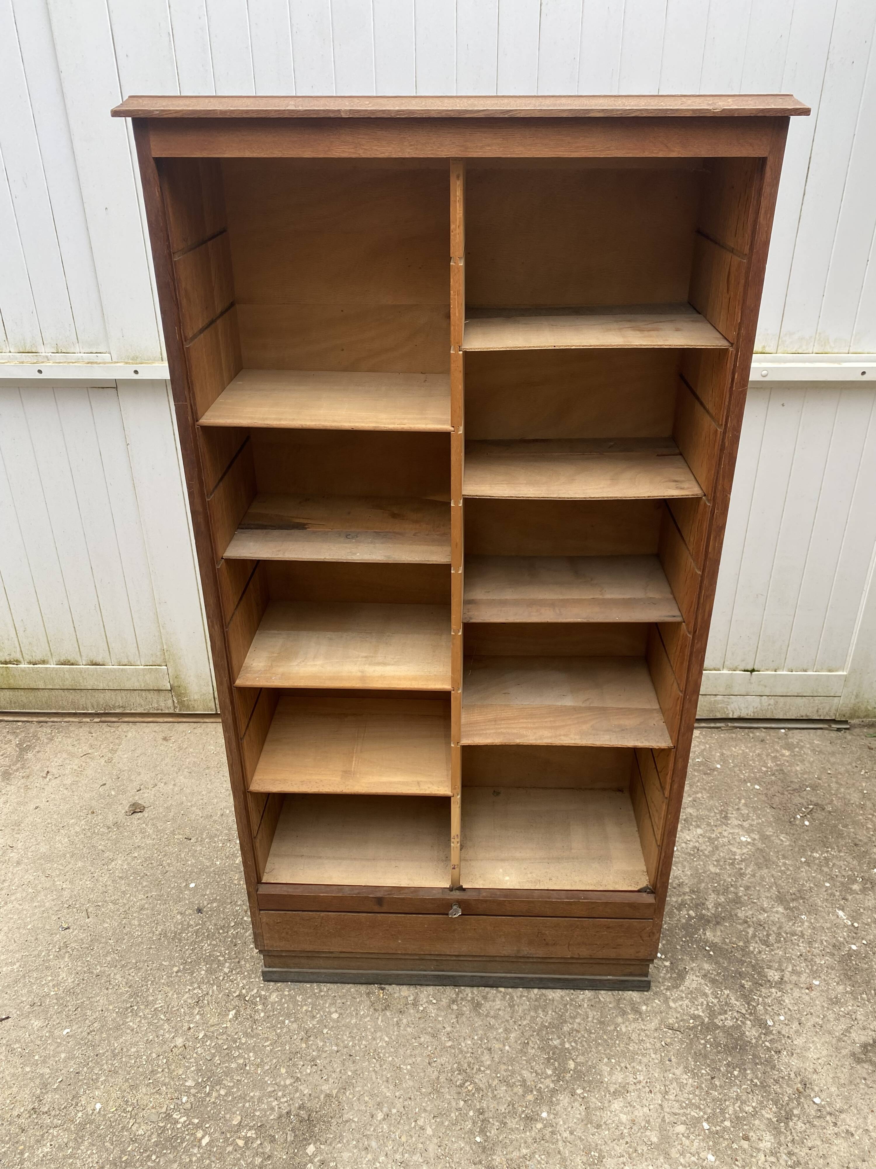 Oak two-column filing cabinet with curtains.