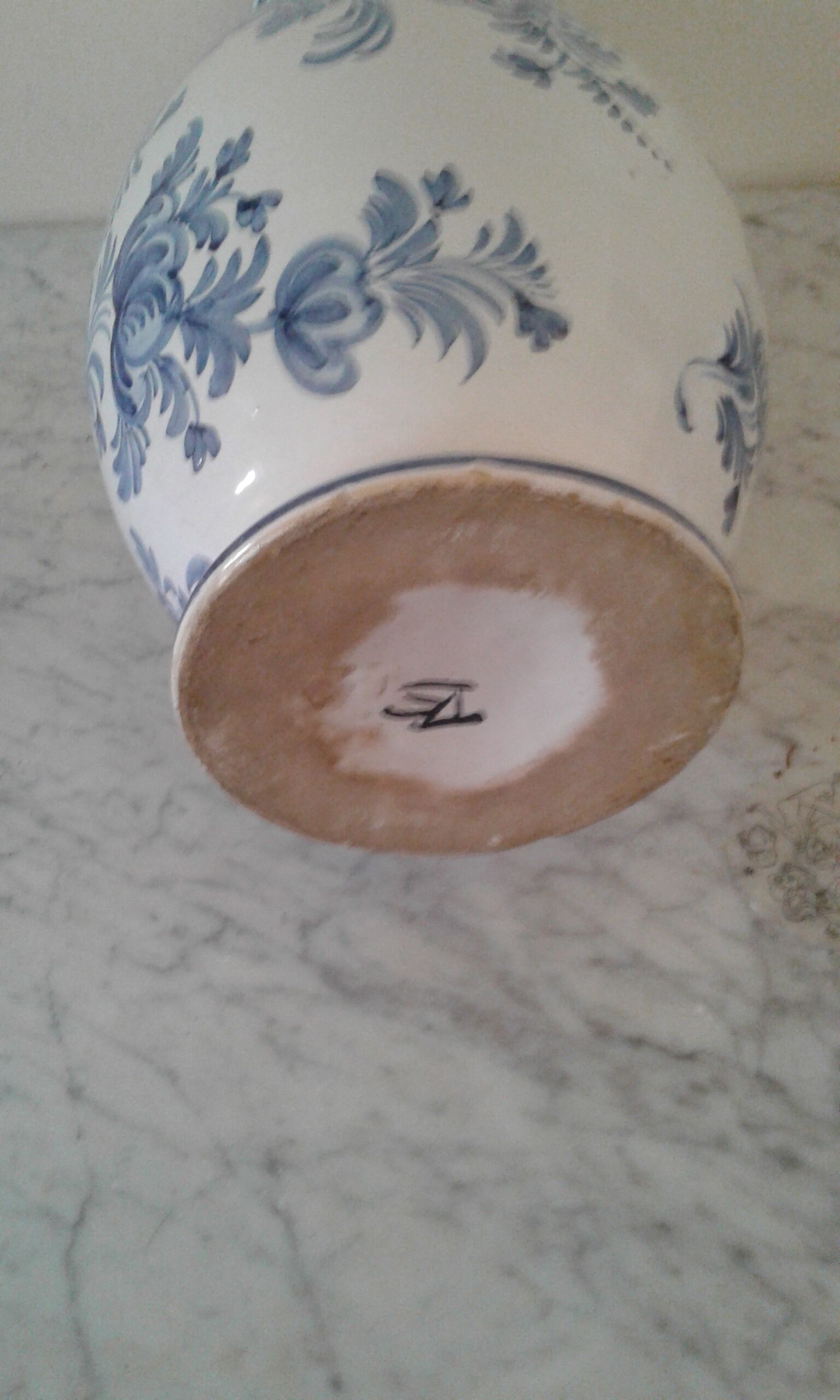 Blue vase adorned with blue and white