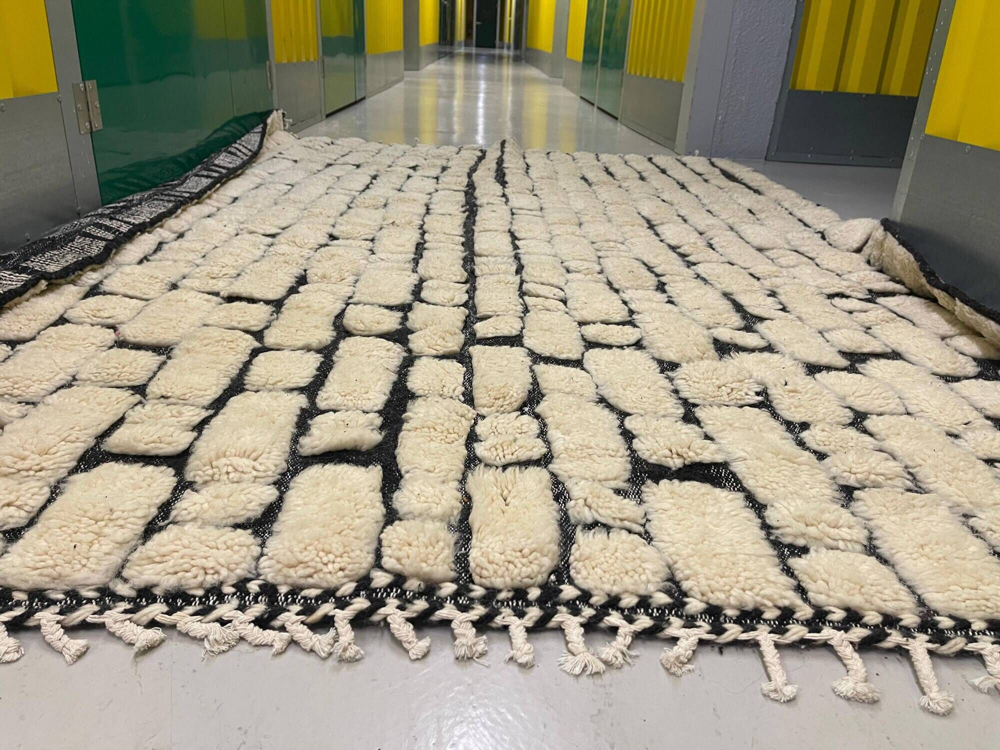 Large cream and black checked Berber rug, 280 × 200 cm.