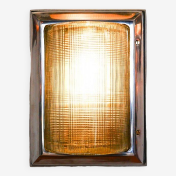 Old wall lamp in polished cast aluminum with double ribbed glass.