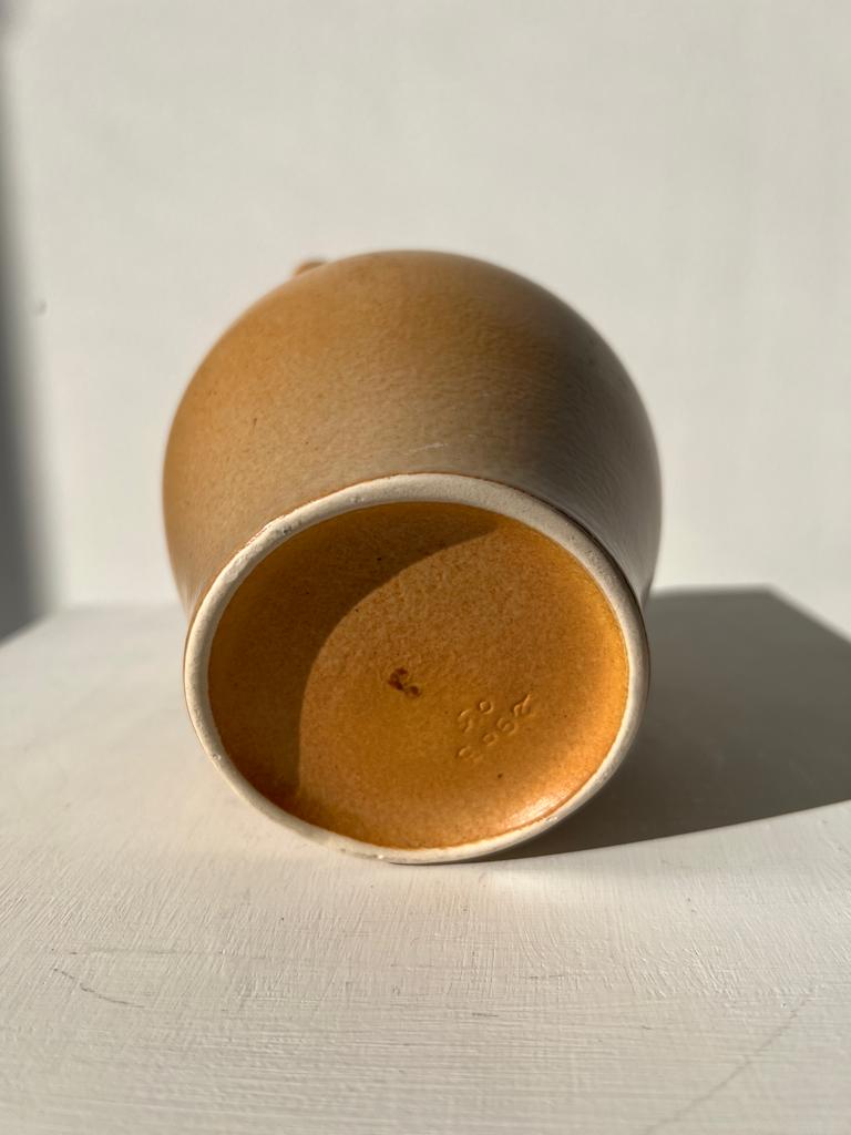 Small pitcher in light beige sandstone