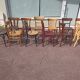 Set of 12 mismatched wooden bistro chairs