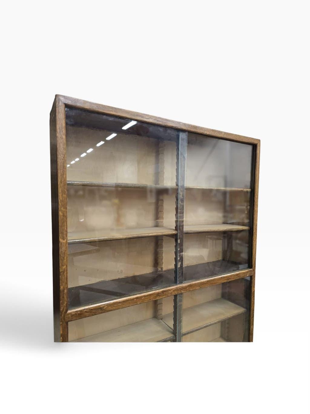 Vintage shallow wooden display shelf with sliding glass doors.