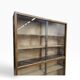 Vintage shallow wooden display shelf with sliding glass doors.